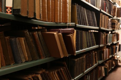 Photo of Collection of different books on shelves in library