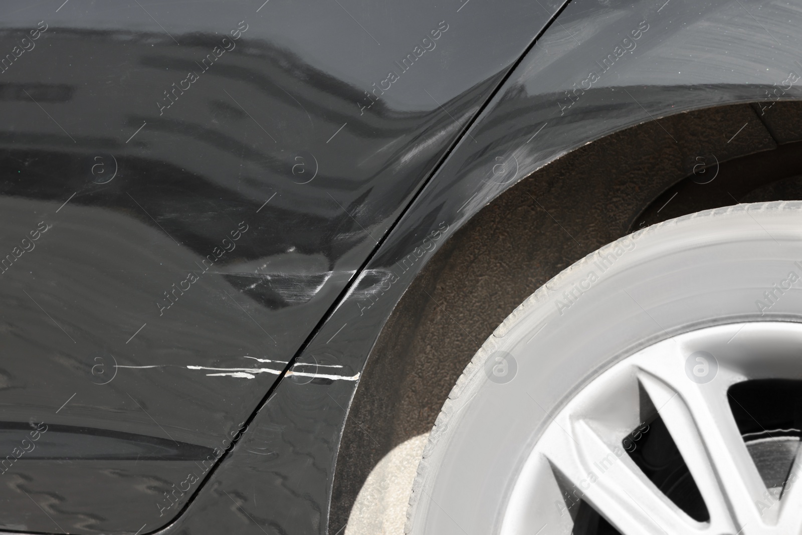 Photo of Modern black car with scratch, closeup view