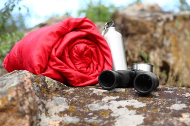 Photo of Rolled sleeping bag and other camping gear outdoors