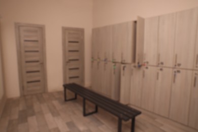 Blurred view of changing room with bench and lockers