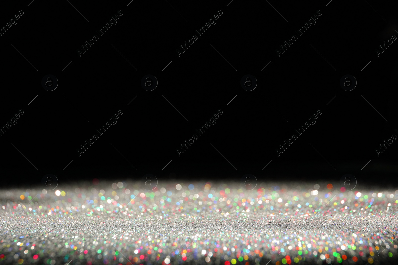 Photo of Shiny colorful glitter on black background, space for text. Bokeh effect