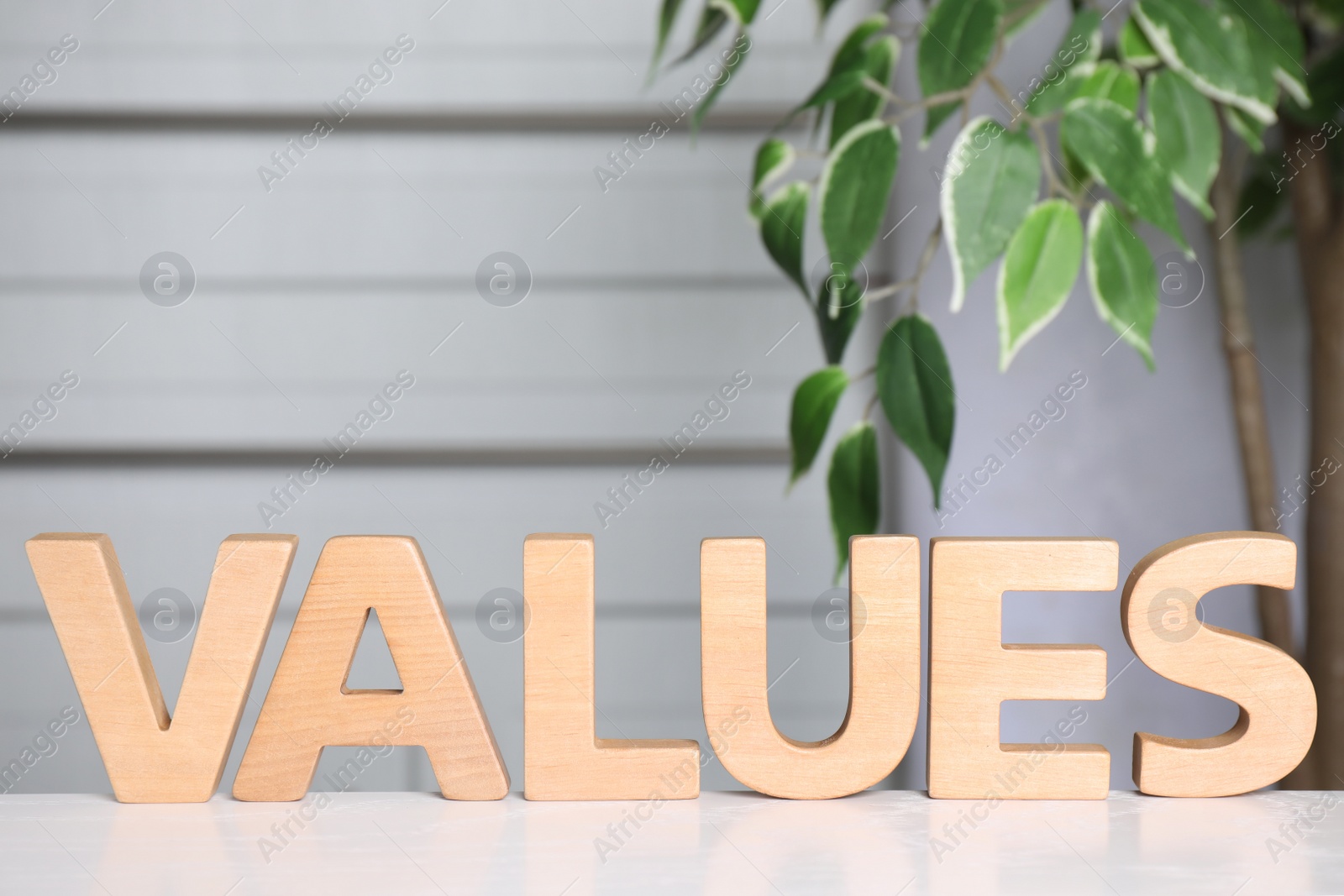 Photo of Word VALUES made of wooden letters on white table