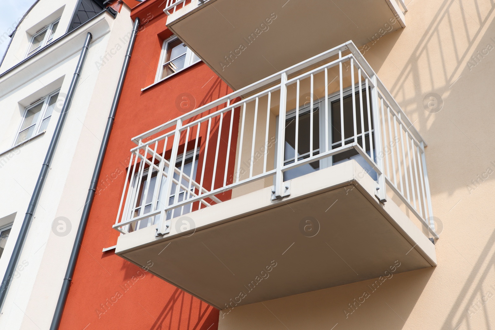 Photo of Exterior of beautiful building with empty balcony, low angle view