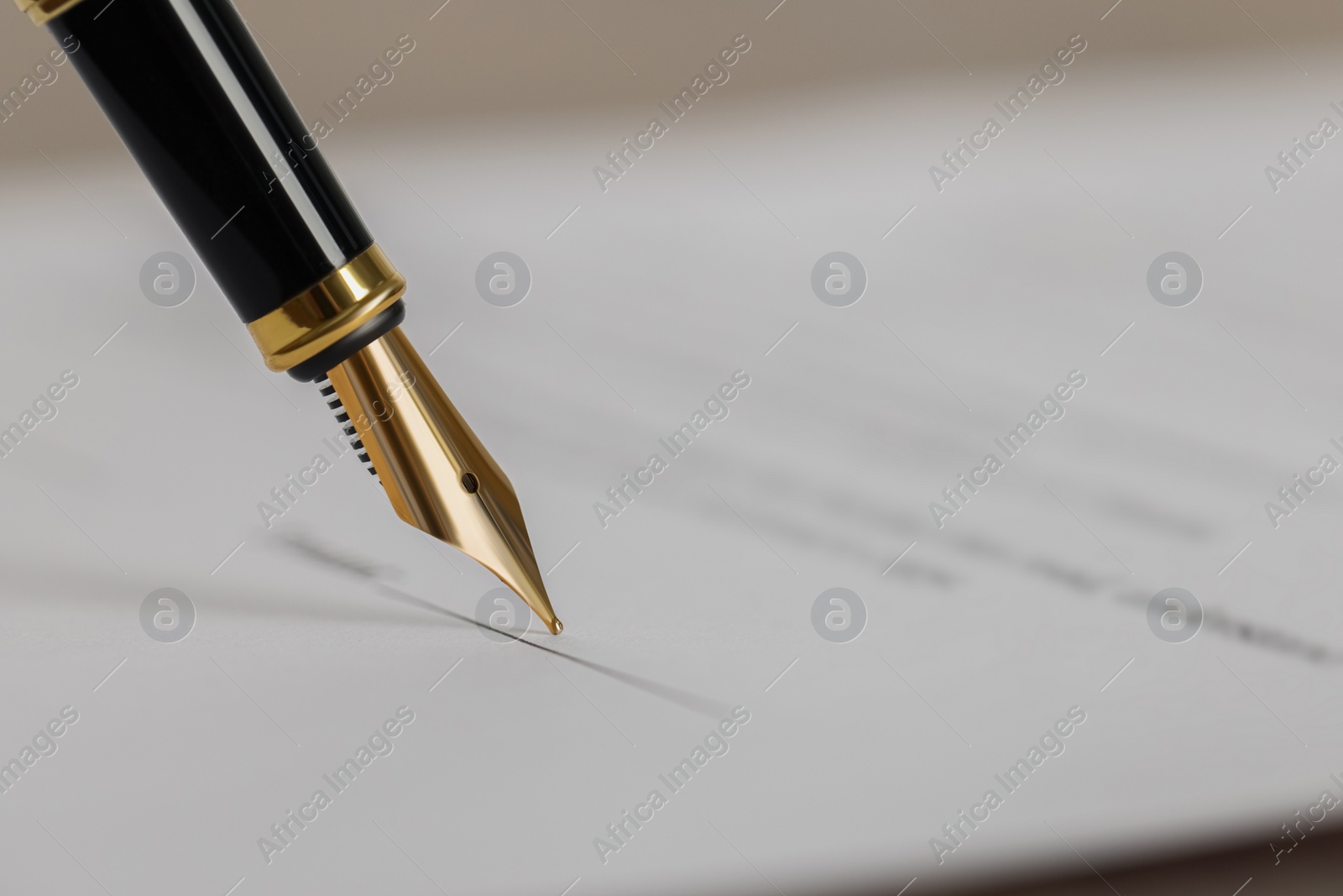 Photo of Writing on document with fountain pen, closeup and space for text. Notary contract