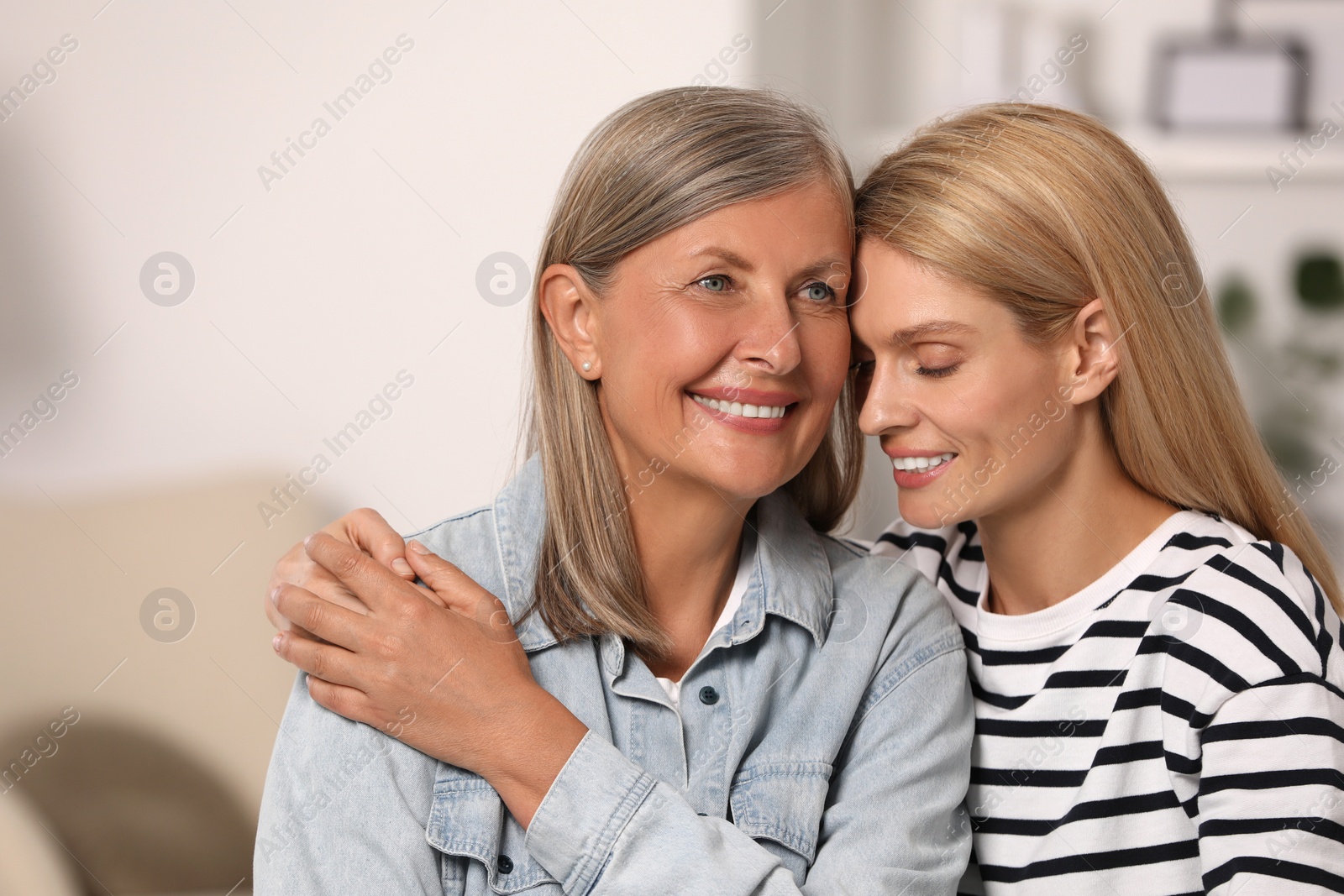 Photo of Happy daughter and her mature mother indoors