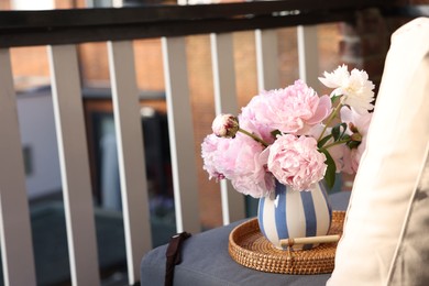 Photo of Beautiful pink peony flowers in vase at balcony. Space for text