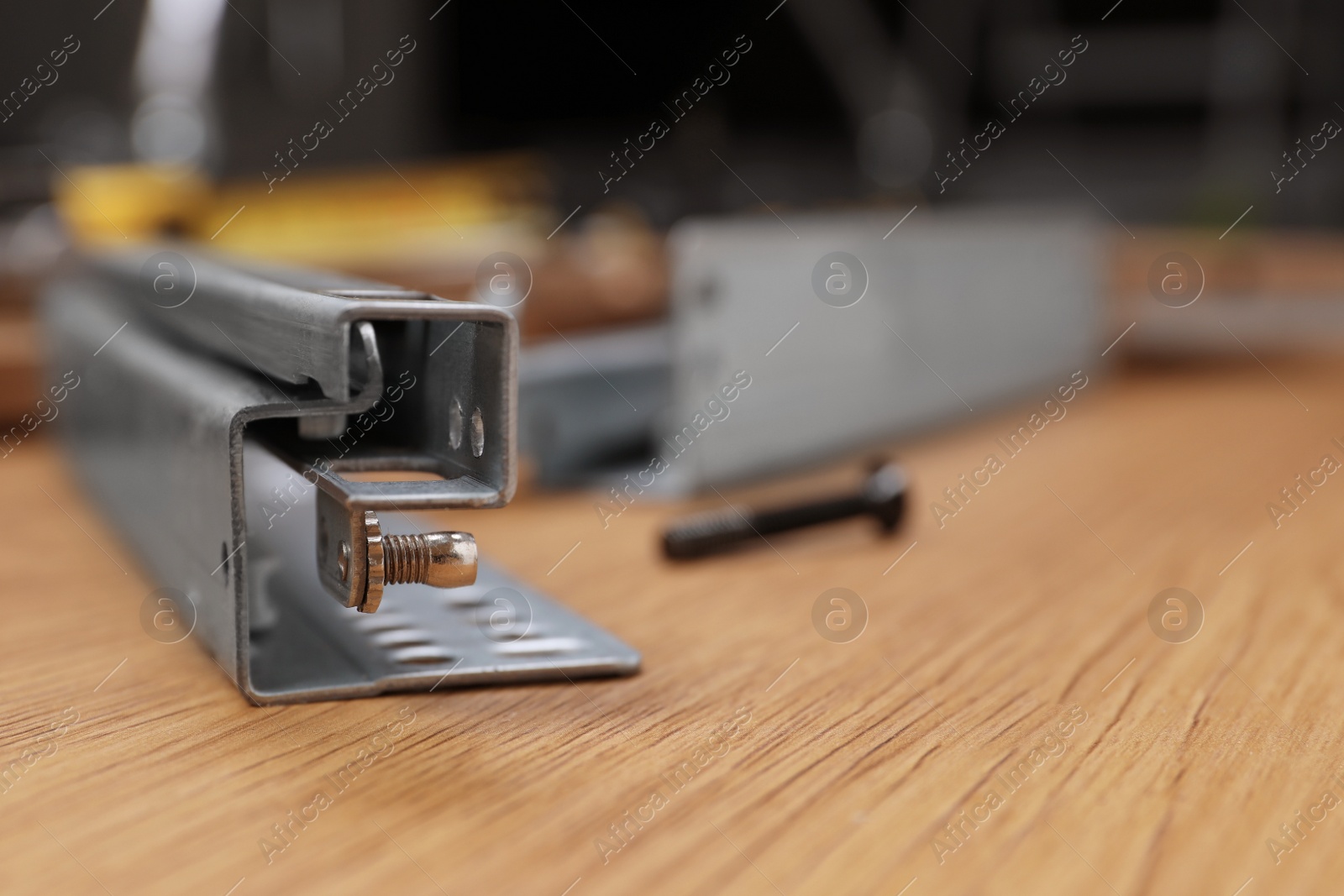 Photo of Furniture assembly parts on wooden table, closeup. Space for text