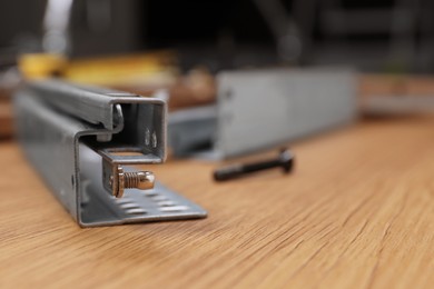 Furniture assembly parts on wooden table, closeup. Space for text