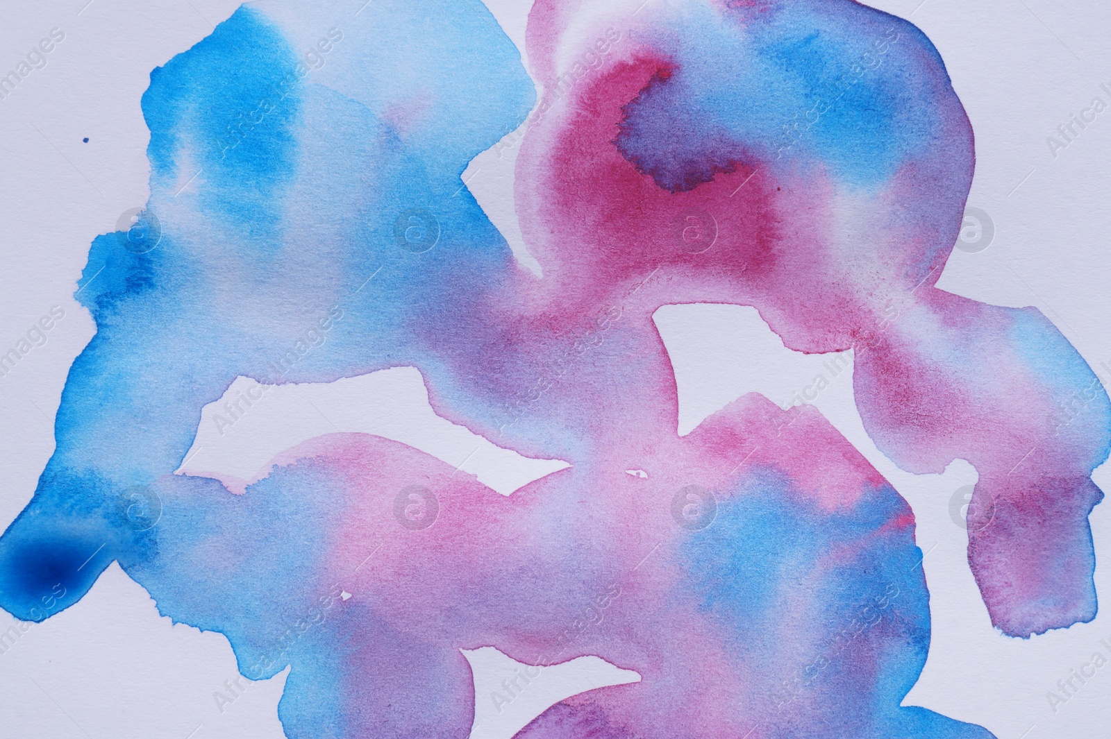 Photo of Colorful watercolor blots on white background, top view