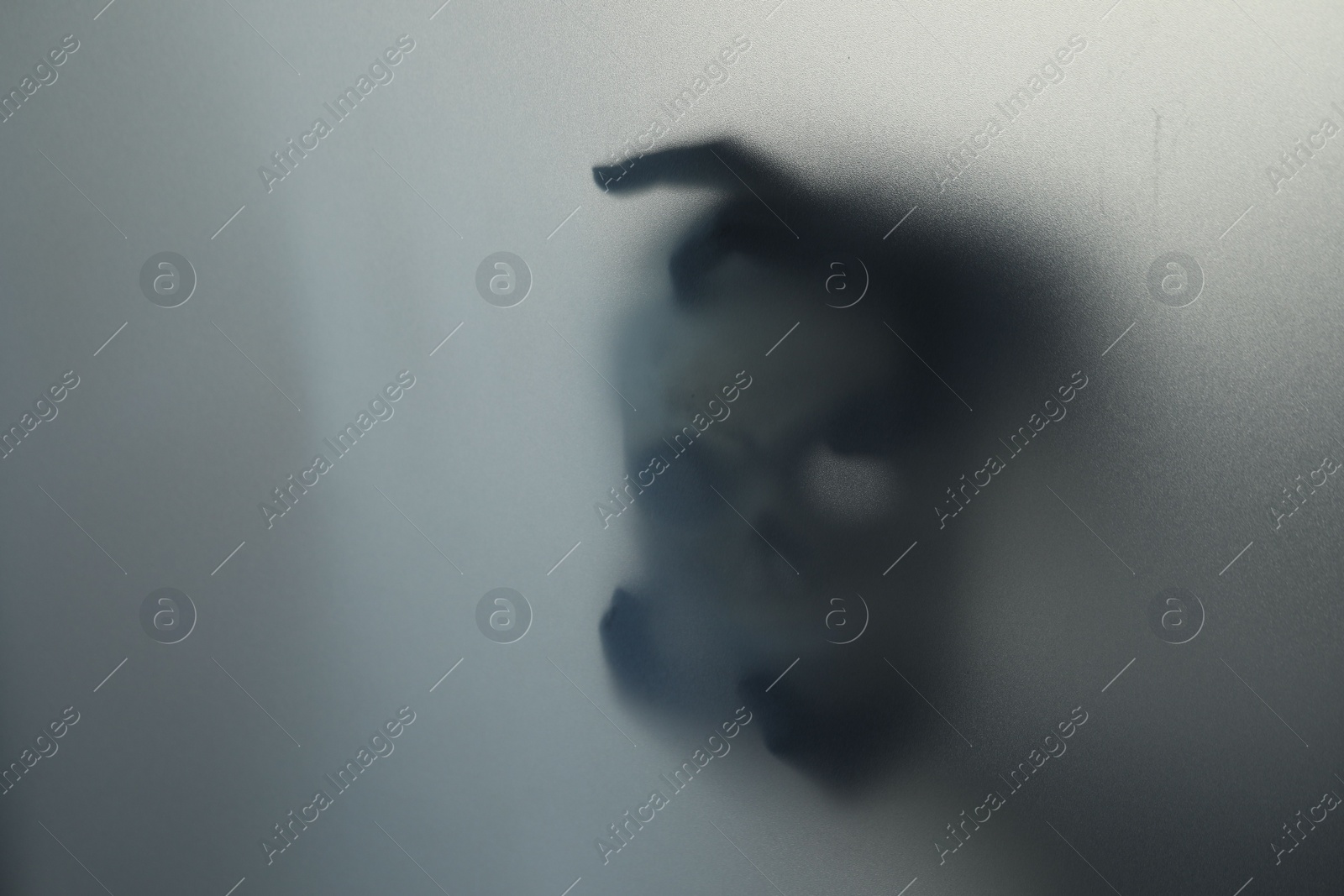 Photo of Silhouette of creepy ghost with skull behind cloth, space for text