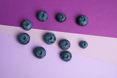 Photo of Flat lay composition with tasty blueberry on color background