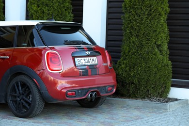 Photo of Lviv, Ukraine - May 10, 2022: Red Mini Cooper S parked outdoors