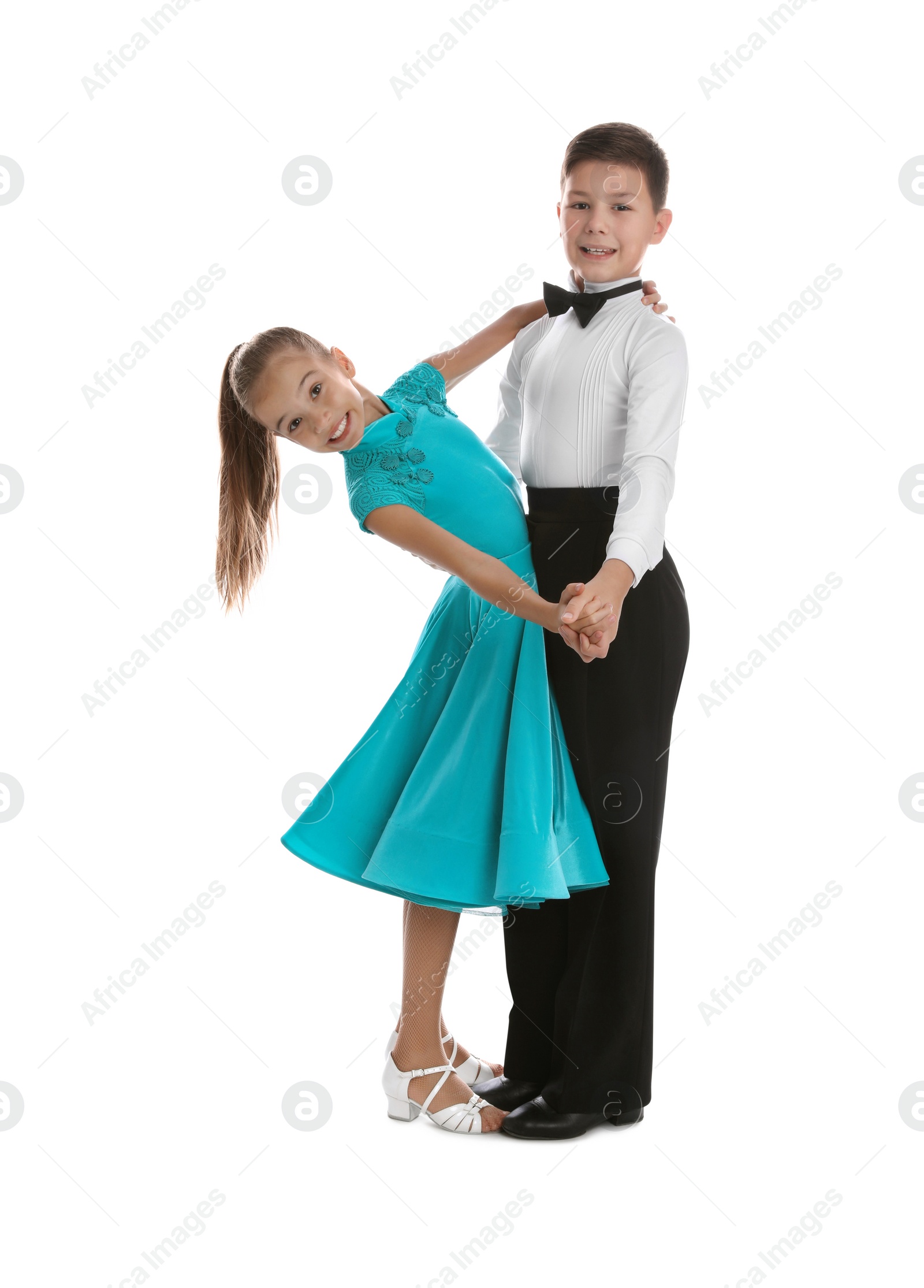 Photo of Beautifully dressed couple of kids dancing on white background