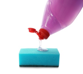 Photo of Pouring cleaning product for dish washing onto sponge on white background