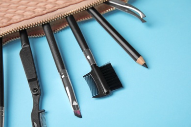 Photo of Set of professional eyebrow tools on blue background