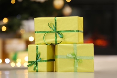 Beautifully wrapped gift boxes against blurred festive lights. Christmas celebration