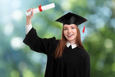 Image of Happy student with graduation hat and diploma on blurred background