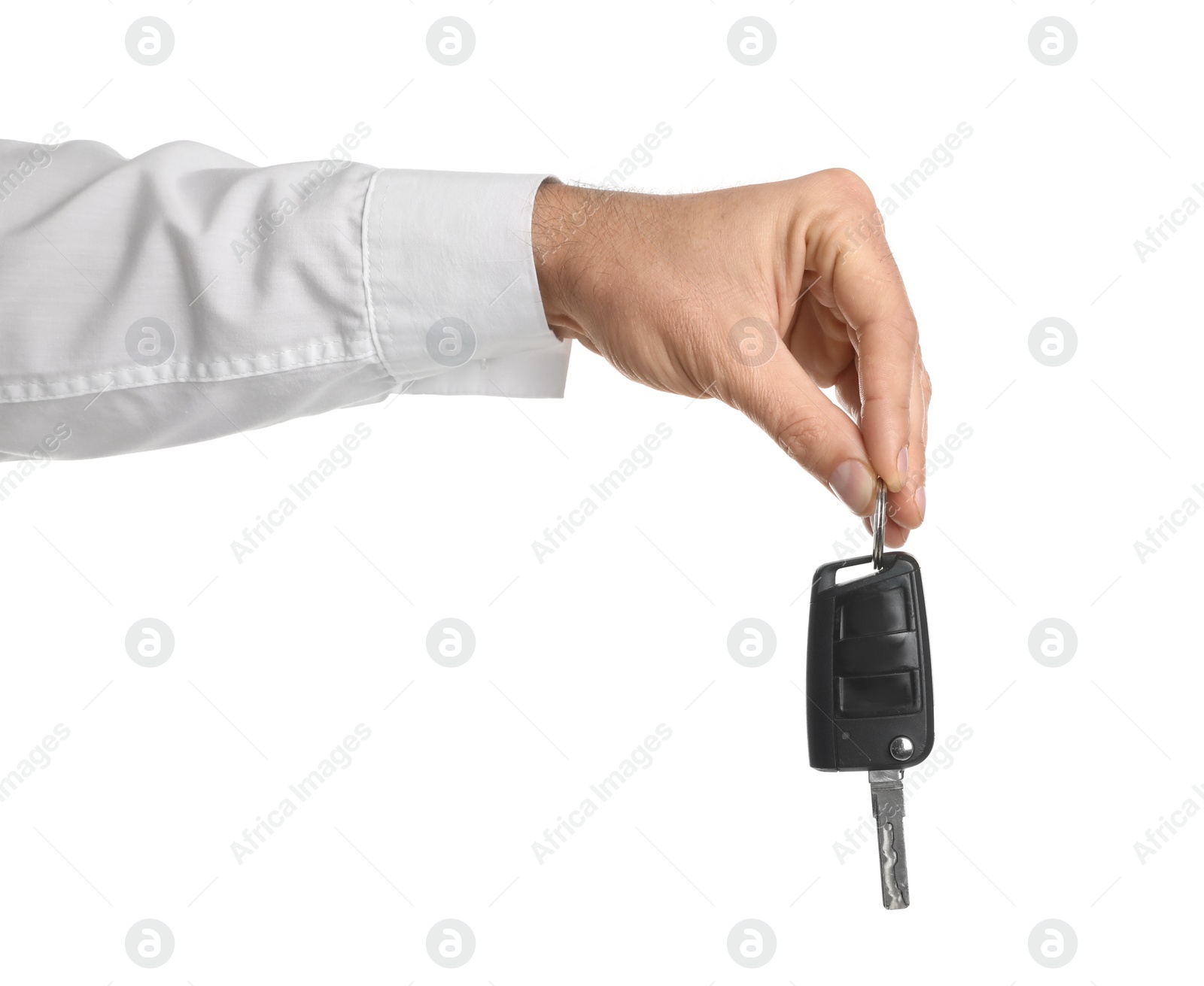 Photo of Man holding key on white background, closeup. Car buying