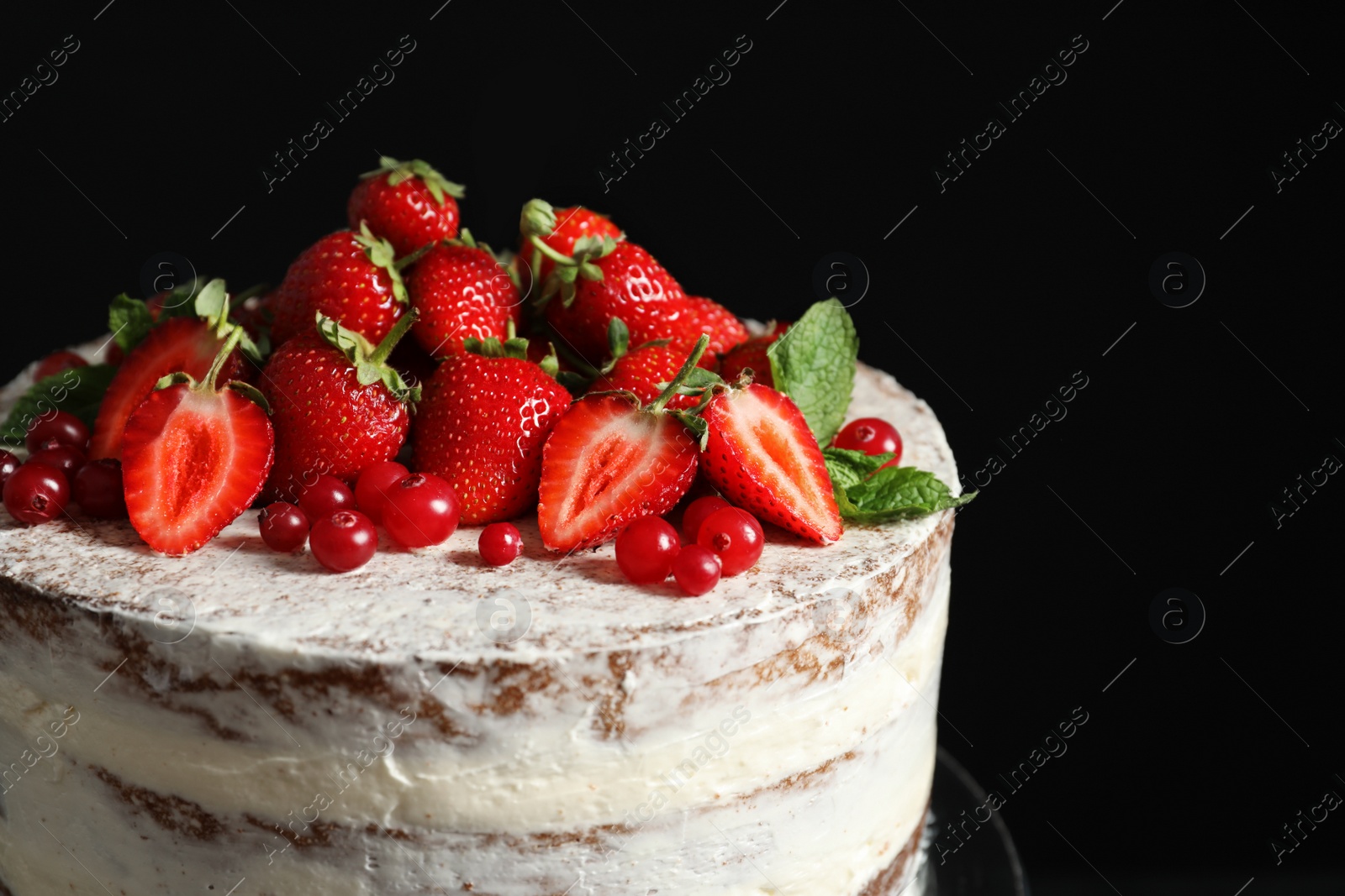 Photo of Delicious homemade cake with fresh berries on black background, closeup