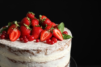 Delicious homemade cake with fresh berries on black background, closeup