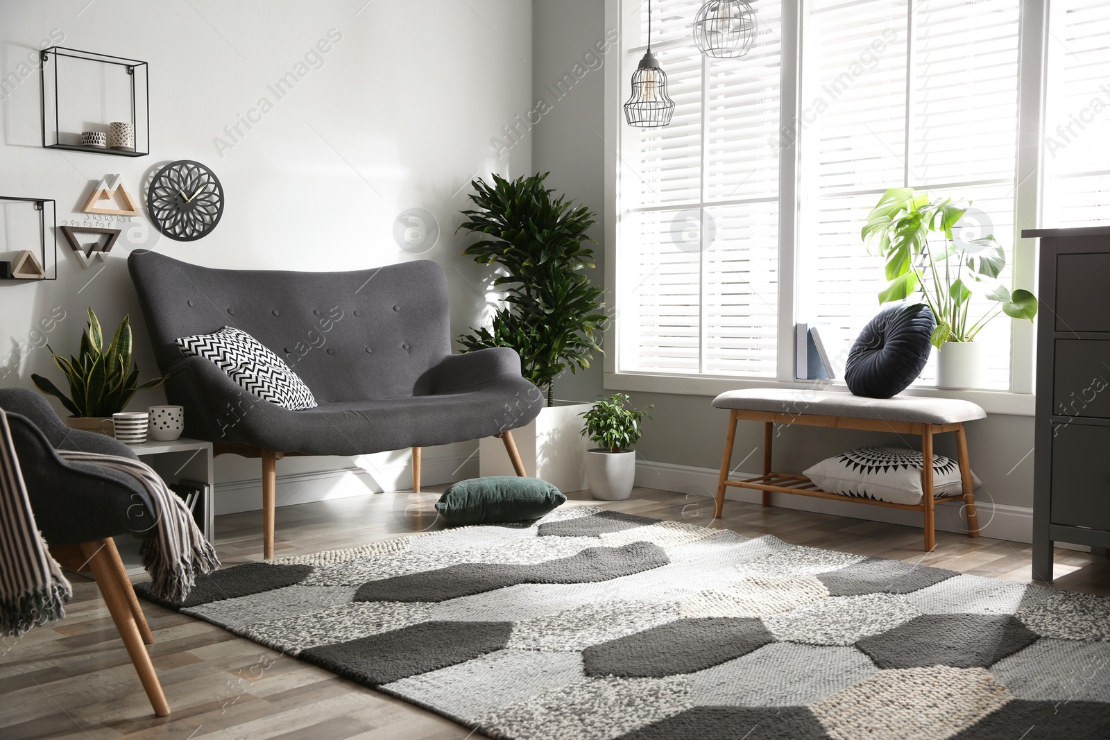Photo of Stylish grey sofa in modern living room interior