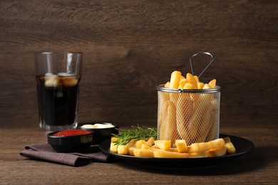 Delicious French fries served with sauces on wooden table