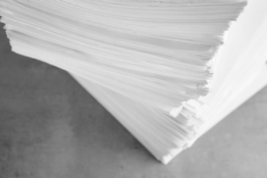 Photo of Stack of blank paper on grey stone table, above view