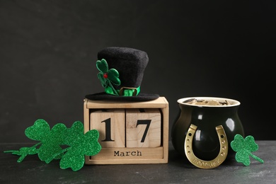 Leprechaun's hat, block calendar and St. Patrick's day decor on black background