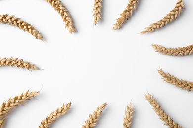 Photo of Frame of wheat on white background, flat lay. Space for text
