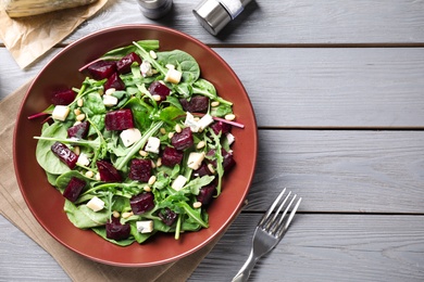 Photo of Fresh delicious beet salad on grey wooden table, flat lay. Space for text
