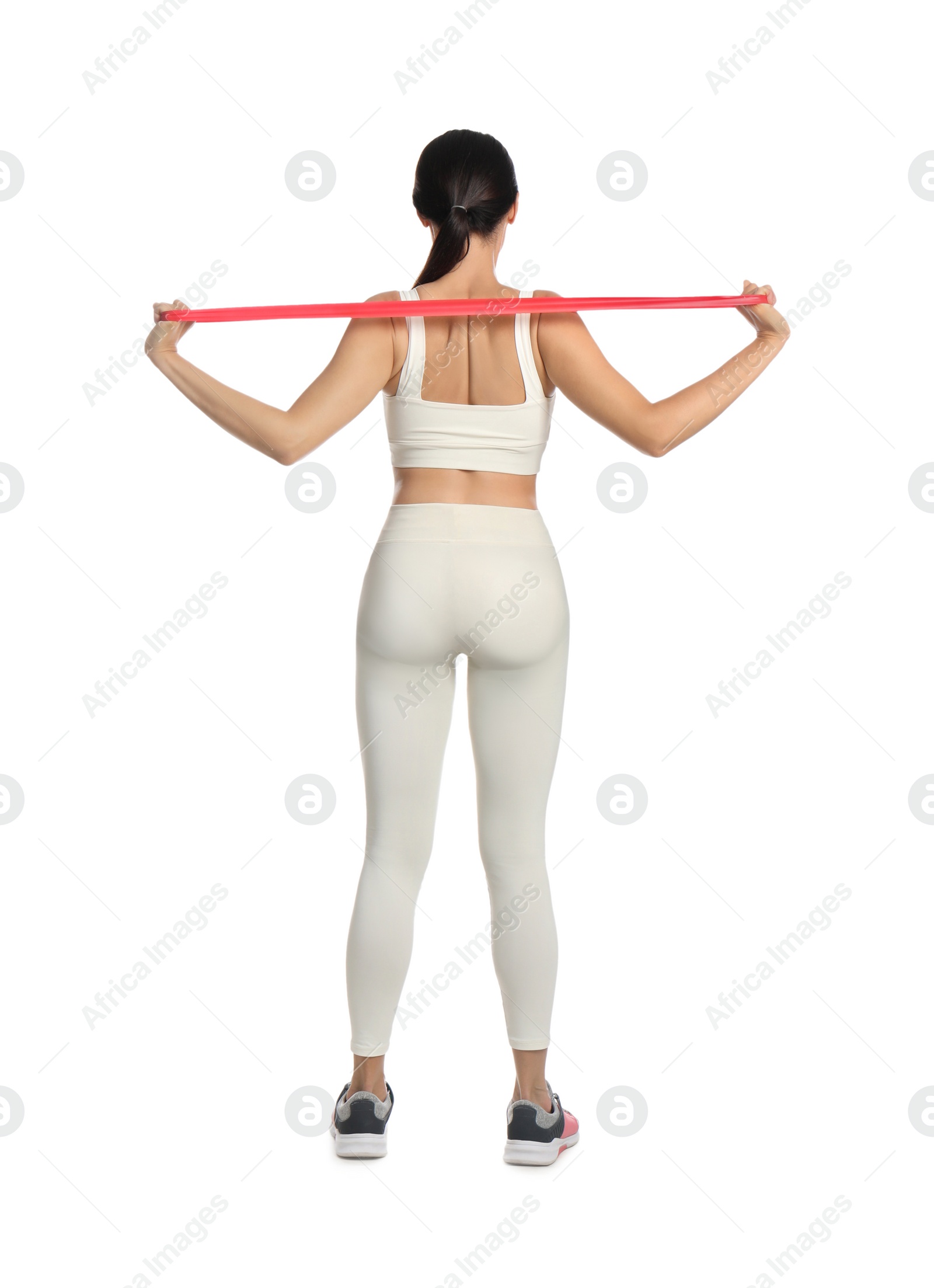 Photo of Woman doing sportive exercise with fitness elastic band on white background, back view