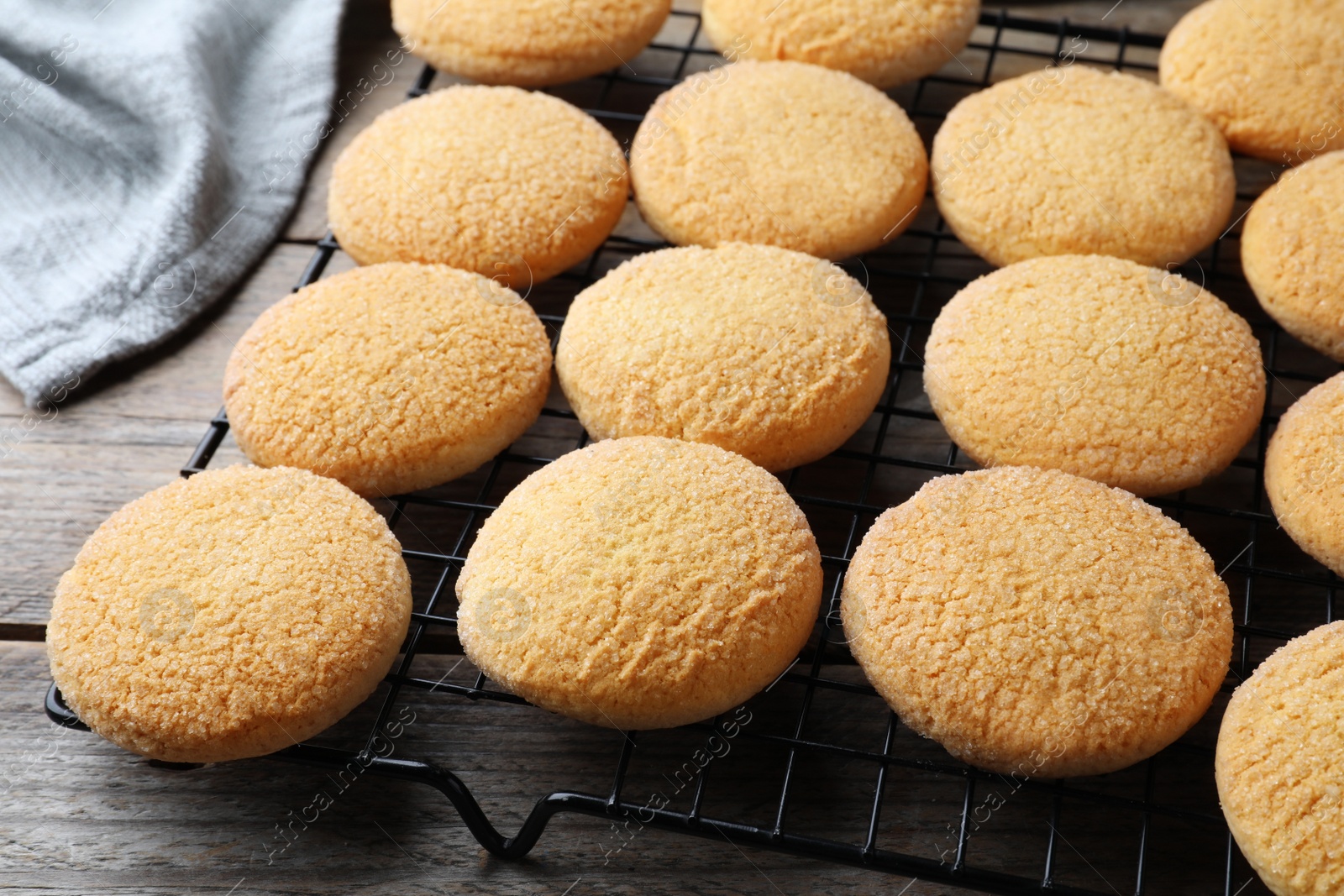 Photo of Many tasty sugar cookies on wooden table, closeup