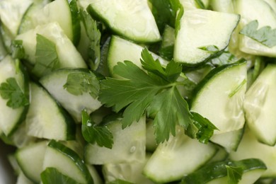 Delicious cucumber salad as background, top view