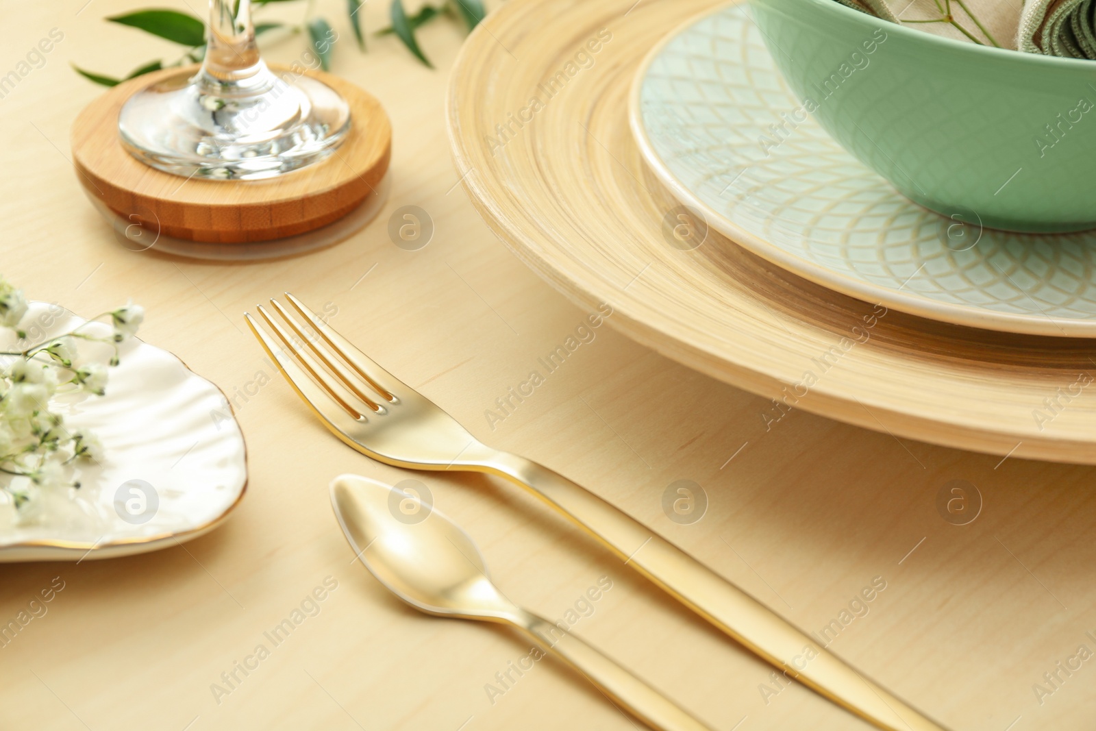 Photo of Elegant table setting with with golden cutlery, closeup
