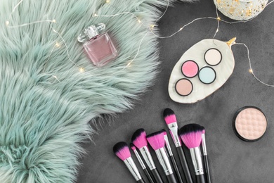 Photo of Composition with makeup products and brushes on grey background