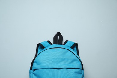 Photo of Stylish blue backpack on light background, top view