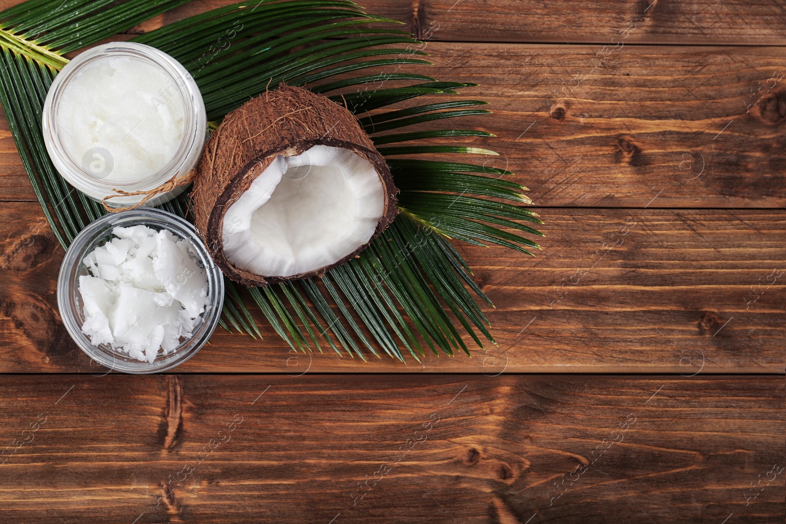 Photo of Flat lay composition with organic coconut oil on wooden table. Healthy cooking