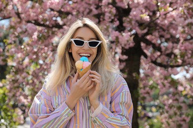 Photo of Young woman with icecream in beautiful park