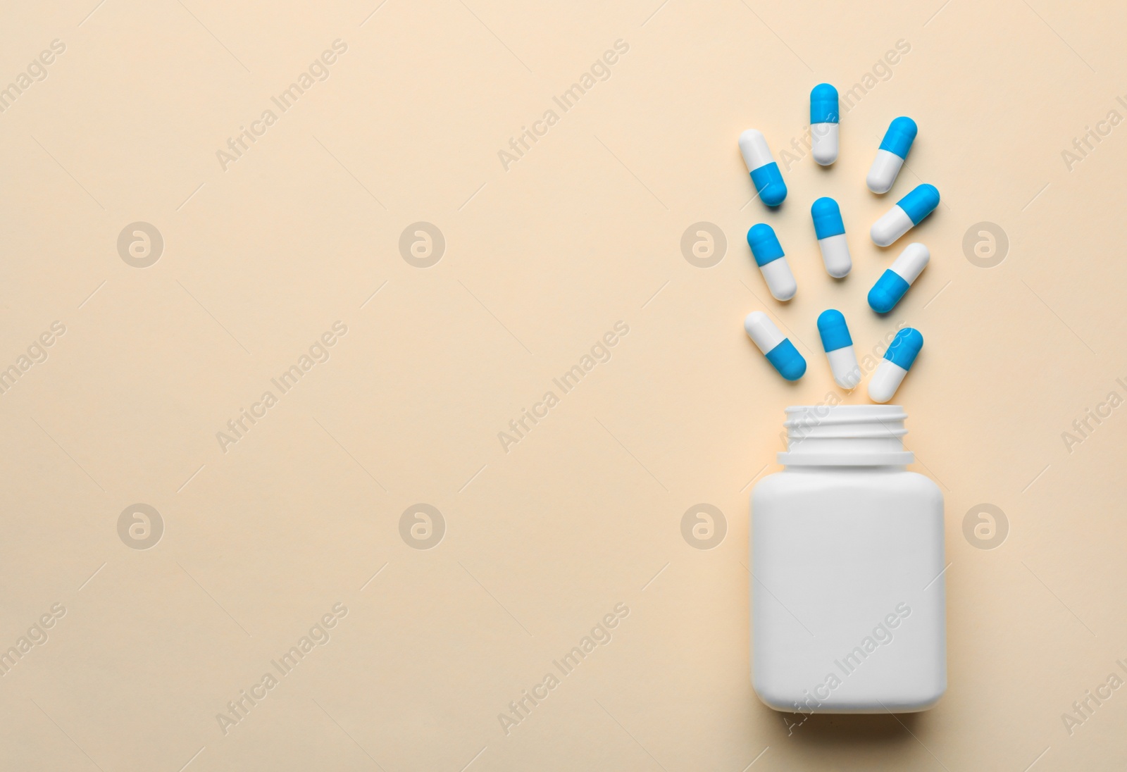 Photo of Bottle with pills on color background, flat lay. Space for text