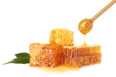 Photo of Pouring honey onto fresh combs on white background