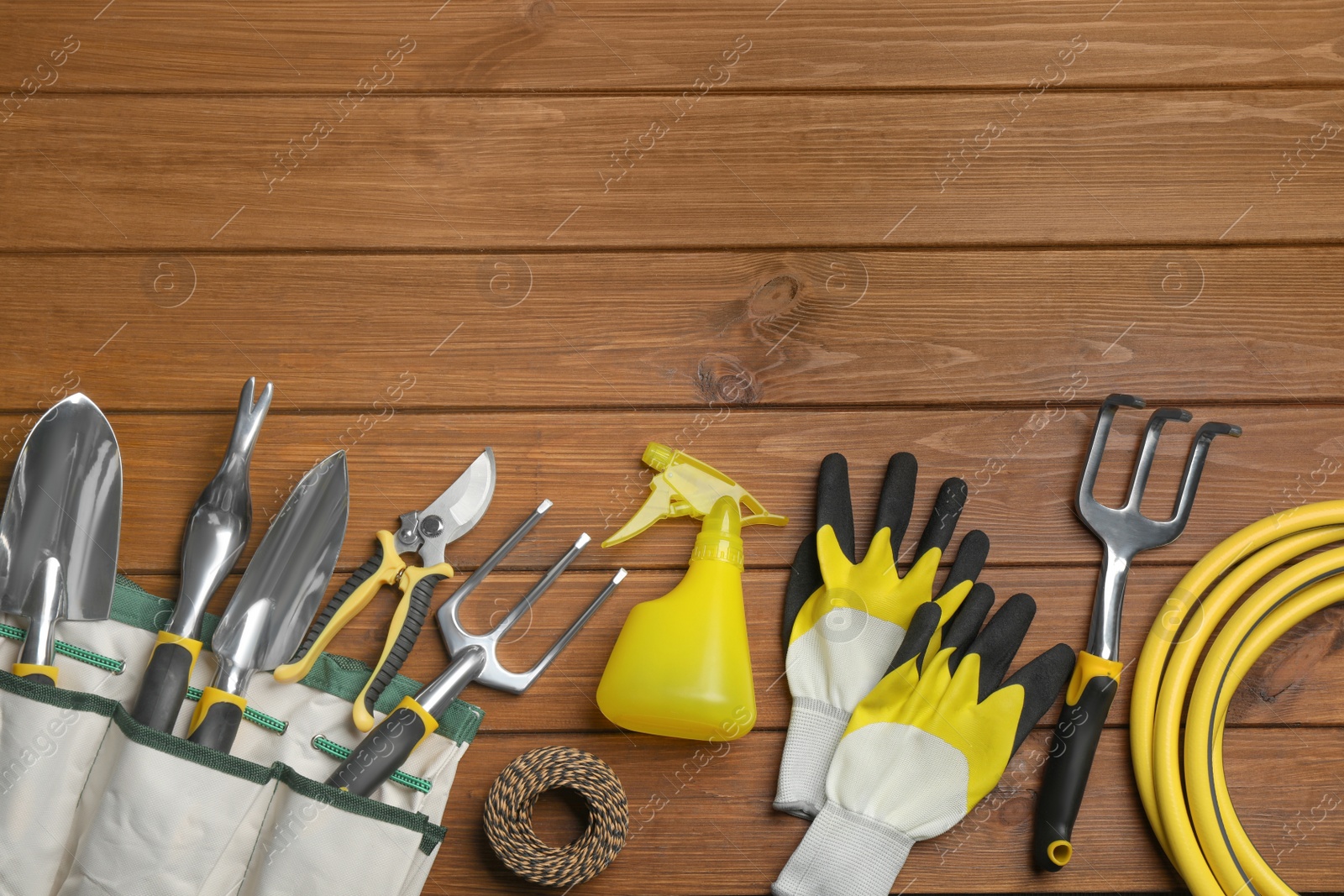 Photo of Flat lay composition with gardening tools on wooden background, space for text