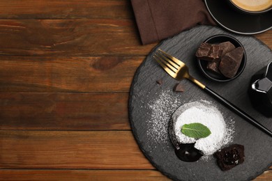 Photo of Delicious fresh fondant with hot chocolate and mint on wooden table, flat lay. Space for text