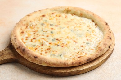 Photo of Delicious cheese pizza on beige textured table, closeup