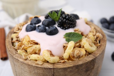 Tasty granola, yogurt and fresh berries in bowl, closeup. Healthy breakfast