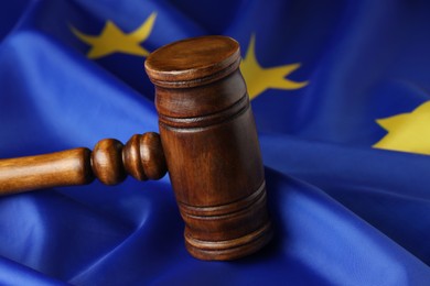 Wooden judge's gavel on flag of European Union, closeup
