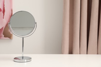 Photo of Mirror on white dressing table, space for text