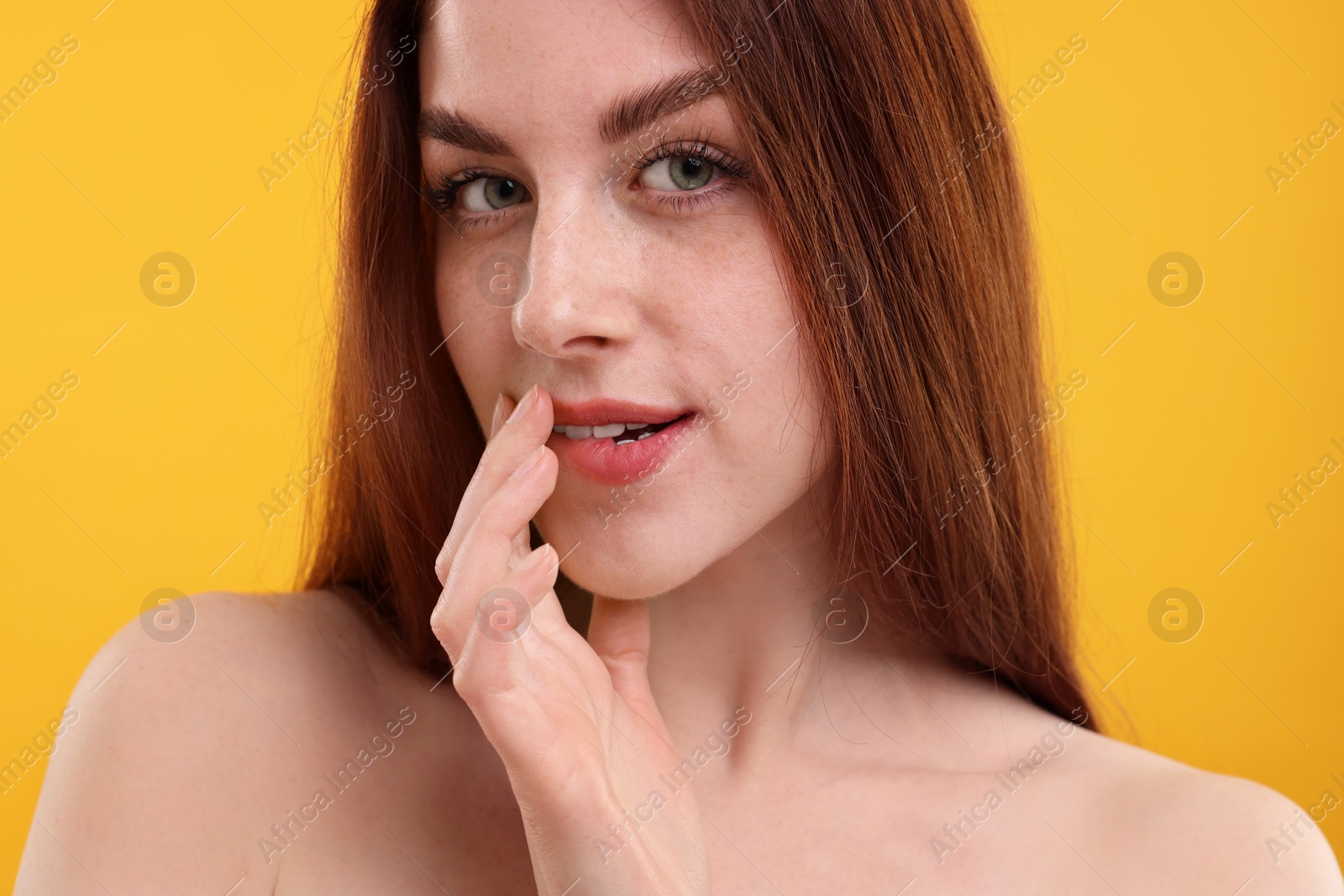 Photo of Portrait of beautiful woman with freckles on yellow background, closeup