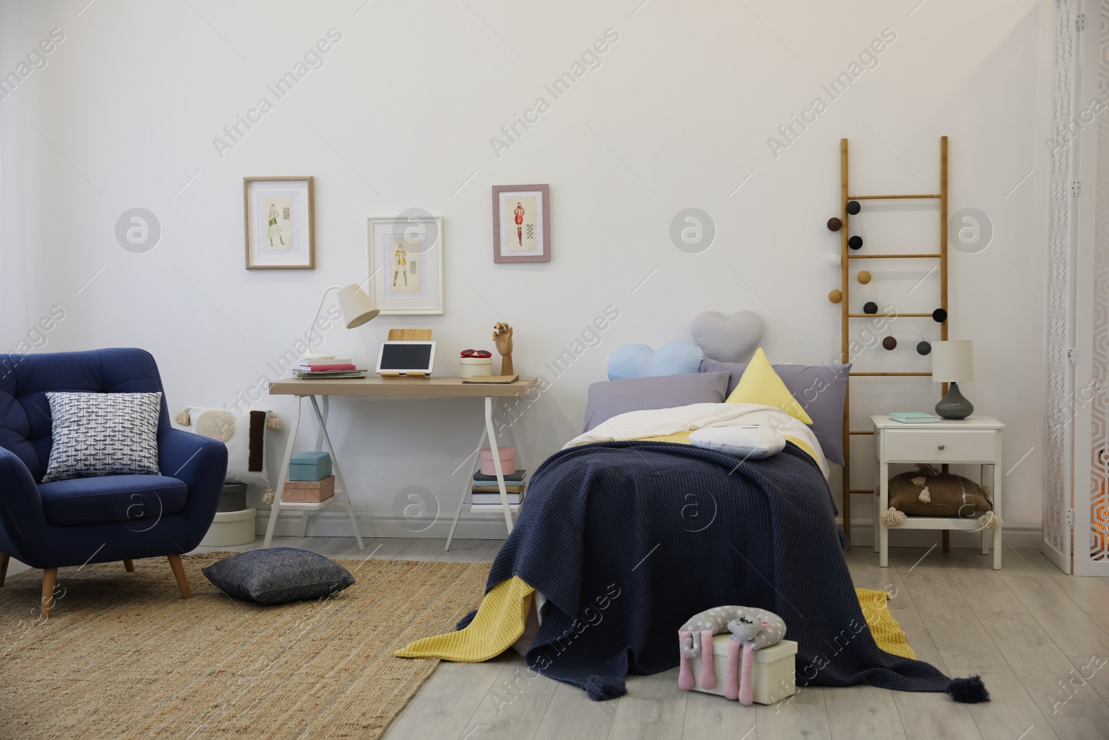 Photo of Modern teenager's room interior with bed and armchair