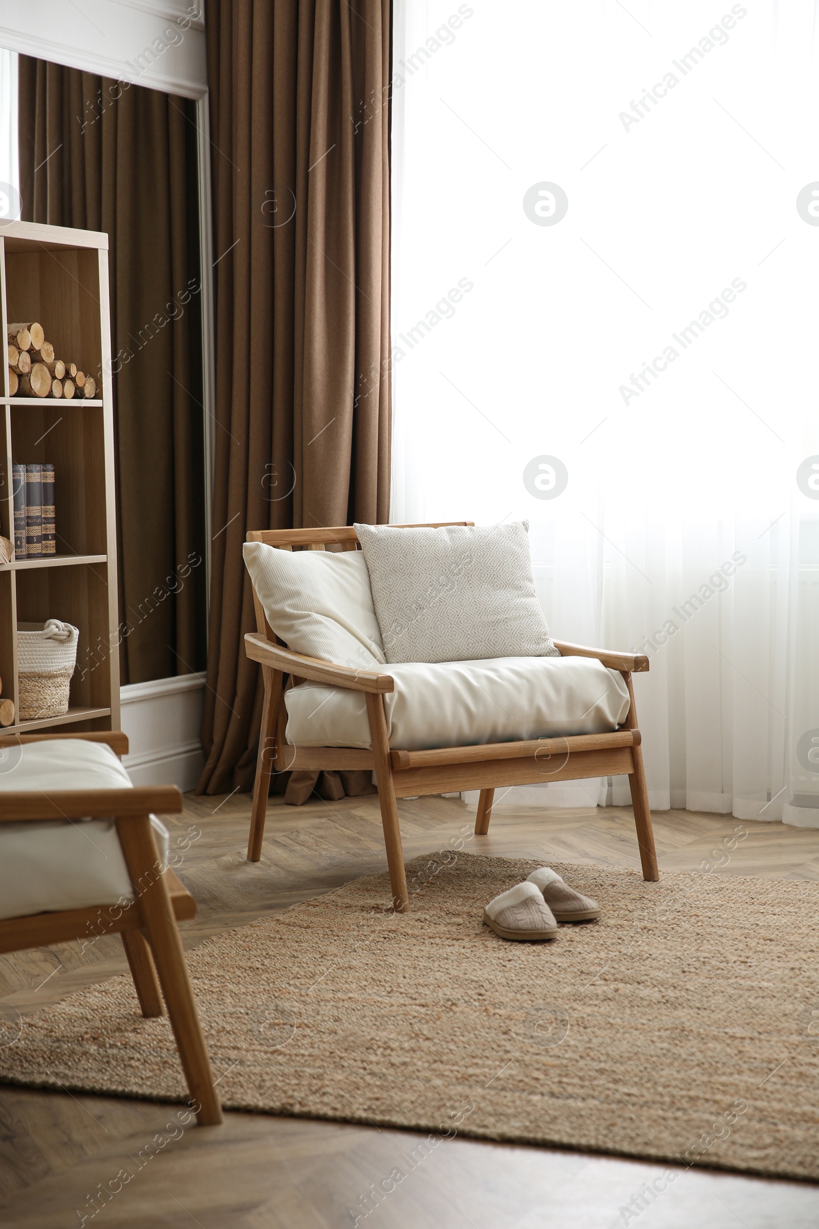 Photo of Armchair near window in modern room. Interior design