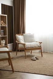 Armchair near window in modern room. Interior design